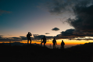 Fototapeta na wymiar sunset photographers silhouette in horizont
