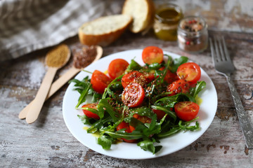 Healthy salad with arugula, cherry tomatoes and seeds. Diet concept.