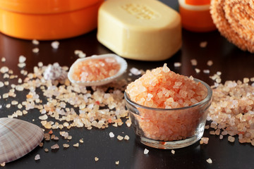 Pink Himalayan salt crystals shell soap towel. Spa set. Dark background, Selective focus.