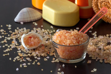 Pink Himalayan salt crystals shell soap towel. Spa set. Dark background. Selective focus.