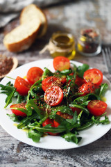 Healthy salad with arugula, cherry tomatoes and seeds. Diet concept.