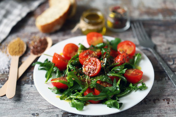 Healthy salad with arugula, cherry tomatoes and seeds. Diet concept.