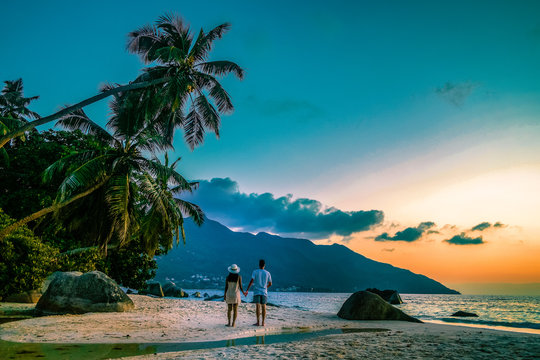 Seychelles tropical islands, Praslins Island Seychelles with couple walking on the tropical beach with palm trees