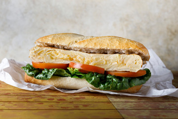 Omelette sandwich with lettuce and tomato
