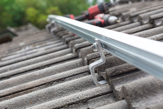 Close Up Of Mounting Rail For Photovoltaic System On Roof Building Site