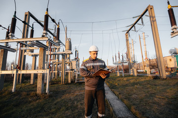 The energy engineer inspects the equipment of the substation. Power engineering. Industry