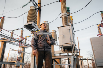 The energy engineer inspects the equipment of the substation. Power engineering. Industry