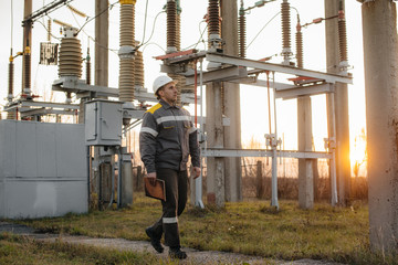 The energy engineer inspects the equipment of the substation. Power engineering. Industry