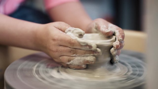 Child making pottery