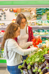 Teen girls shopping supermarket. Young people make the conscious, organic and healthy choice.