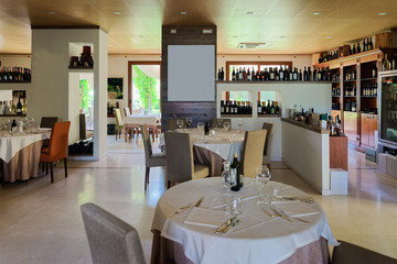 Retro restaurant interior with wine shelves and tables with chair