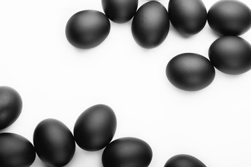 Composition of black easter eggs on a white background. Easter minimalistic concept