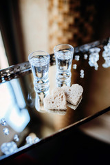 Wedding tradition in Poland. Parents welcome bride and groom with bread, vodka and salt. Decorative tray with food and alcohol. Empty copy space european culture background.	