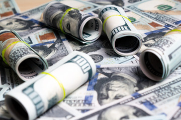 hundred dollar bills and rolls of banknotes. view from above. to close
