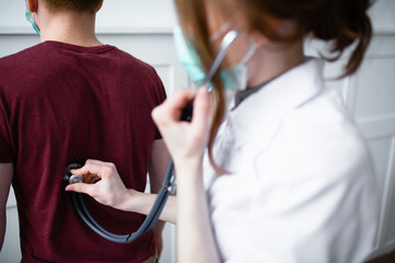 Patient complains to handsome doctor about coughing and feeling unwell