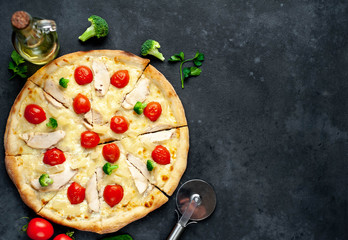 delicious pizza with pineapple, broccoli, tomatoes, mozzarella cheese, chicken fillet on a stone background with copy space for your text