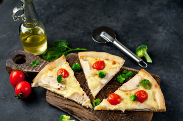 sliced ​​pizza with pineapple, broccoli, tomato, mozzarella, chicken fillet on a stone background with copy space for your text