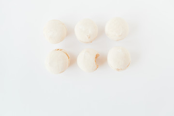 The marshmallows with spoon on the white background.Minimalism.Space for text.Flat lay