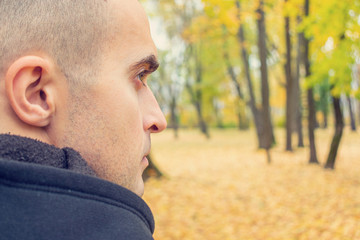 Concept of travel and active lifestyle. Man walking in autumn Park, rear view, close up