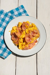Eggs with ham for breakfast on white background