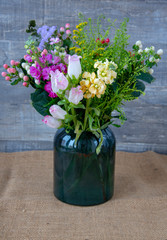 A vase full of various exquisite flowers .