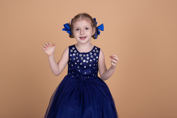 smiling girl in blue dress isolated on neutral background