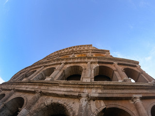 Colosseum exterior in the morning in Rome, Italy. Sky view. Clear day and blue sky. Beautiful pictures