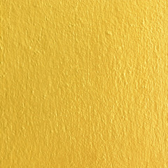 Gold paint on cement wall texture.