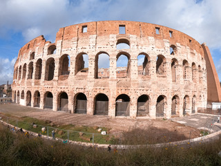 Fototapeta na wymiar Colosseum exterior in the morning in Rome, Italy. Sky view. Clear day and blue sky. Beautiful pictures