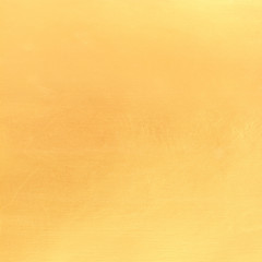 Gold paint on cement wall texture.