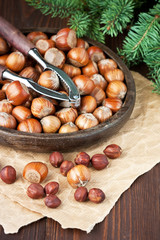 Lot of hazelnut on  wooden table with nutcracker