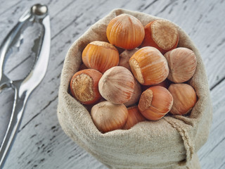 Hazelnuts lie on light wooden boards.Useful hazelnut for health.