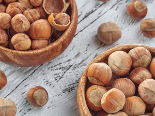 Hazelnuts lie on light wooden boards.Useful hazelnut for health.