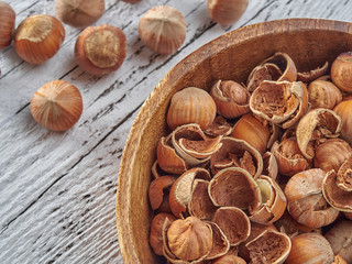 Hazelnuts lie on light wooden boards.Useful hazelnut for health.