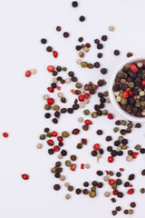 A mixture of multi-colored pepper in a small dish