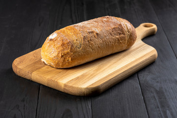 a loaf of bread on a wooden board