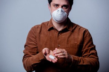 guy uses disinfectant gel on his hands