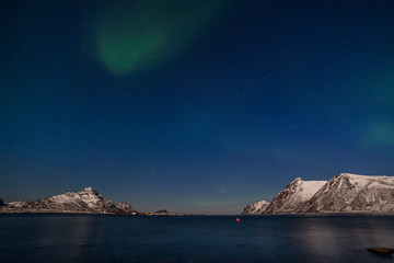 Fototapeta na wymiar amazing northern lights, aurora borealis over the mountains in the North of Europe - Lofoten islands, Norway