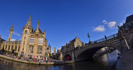 Fototapeta na wymiar Ghent,Belgium,August 2019. Large format panoramic photo: breathtaking cityscape from the St.Michael bridge along the Graslei canal.One of the most beautiful postcards in the city. People stop to watch