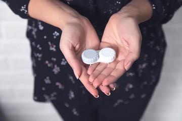 young woman hand holding lenses