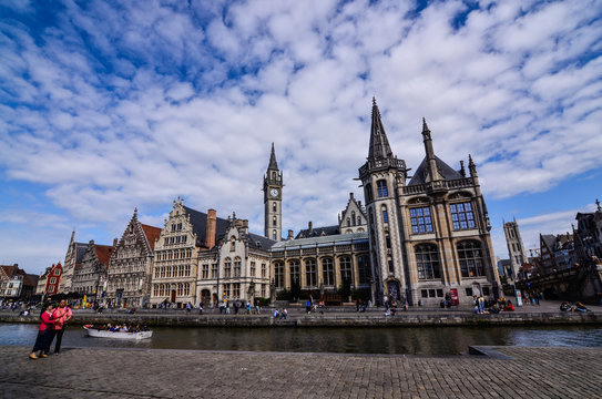 Ghent, Belgium, August 2019. Breathtaking cityscape: from the St. Michael bridge along the Graslei canal. One of the most beautiful postcards in the city. On the left a couple stopped to admire.