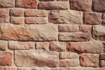 Masonry. The texture of the stone. Brick wall. Natural stone in the fence. Nice background of a strong wall.