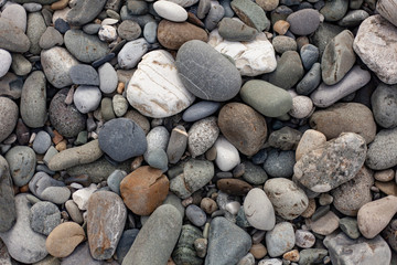 Texture pebbles. Large stones. Beautiful background. Coast. Beautiful gray beach.