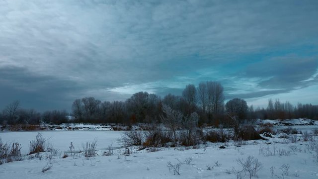 Panorama Evening Winter Landscape. Moving Along Rural Road in Plains. Cloudy Sky Above Snow Covered Field And River. Cold Weather on Winter Holidays