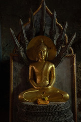 Gold Thai Naga Buddha statue/altar/shrine with serpents in Wat Suwan Kuha cave 