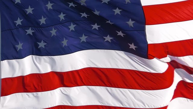 SUPER SLOW MOTION: American Flag Waving. Close up of the United States of America flag fluttering in the wind on an isolated beach. Full Frame.