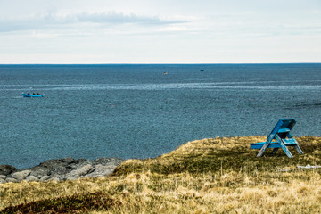 Fototapeta na wymiar Fishing boat out in Little Beachy Cove. Cow Head, Newfoundland, Canada