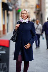 mature woman tourist walks the streets of the town