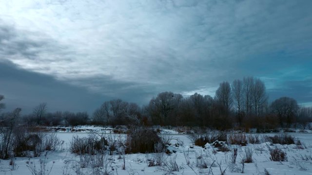 Panorama Evening Winter Landscape. Moving Along Rural Road in Plains. Cloudy Sky Above Snow Covered Field And River. Cold Weather on Winter Holidays