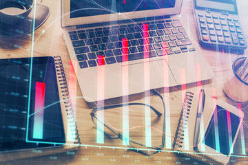 Financial graph colorful drawing and table with computer on background. Double exposure. Concept of international markets.